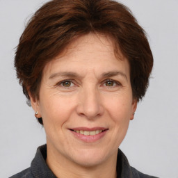 Joyful white adult female with short  brown hair and brown eyes