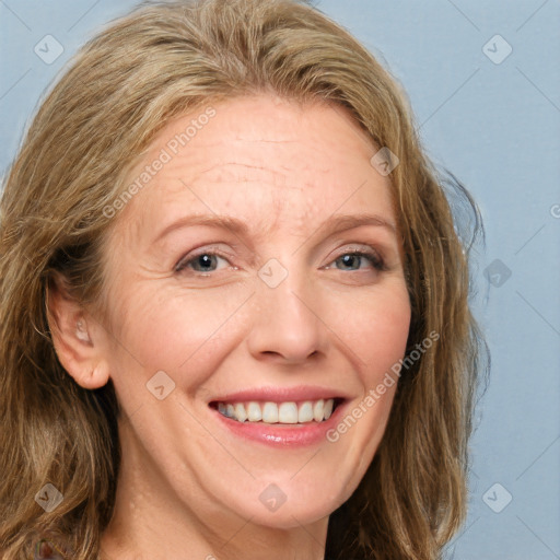 Joyful white adult female with medium  brown hair and blue eyes