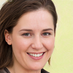 Joyful white young-adult female with long  brown hair and blue eyes