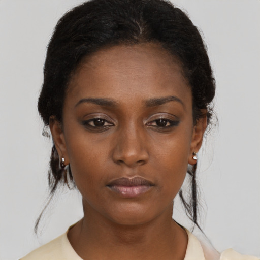 Neutral black young-adult female with medium  brown hair and brown eyes