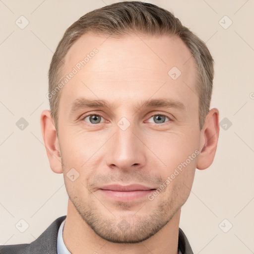 Joyful white young-adult male with short  brown hair and grey eyes