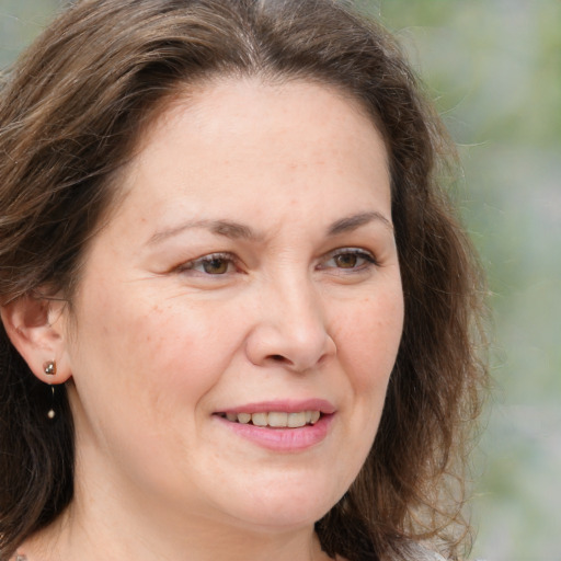 Joyful white adult female with medium  brown hair and grey eyes