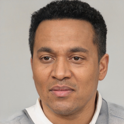 Neutral latino adult male with short  black hair and brown eyes