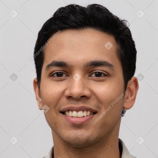 Joyful latino young-adult male with short  black hair and brown eyes