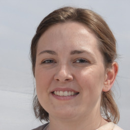 Joyful white young-adult female with medium  brown hair and grey eyes