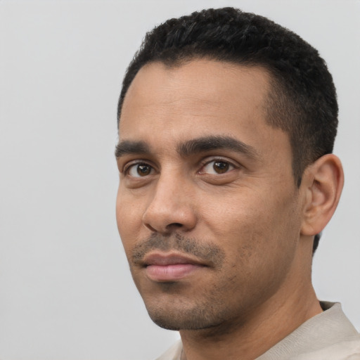 Neutral latino young-adult male with short  black hair and brown eyes