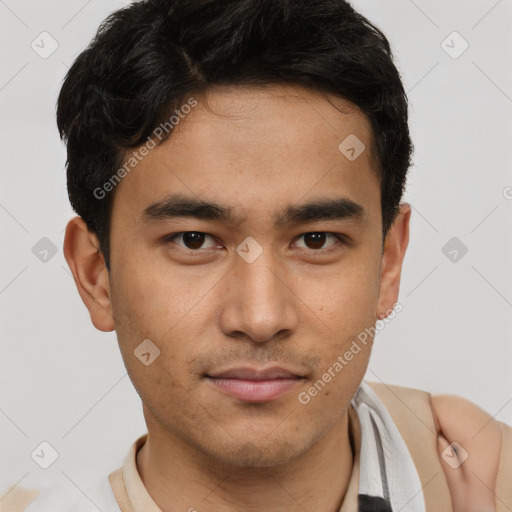 Joyful latino young-adult male with short  brown hair and brown eyes