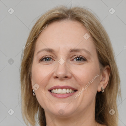 Joyful white adult female with medium  brown hair and grey eyes