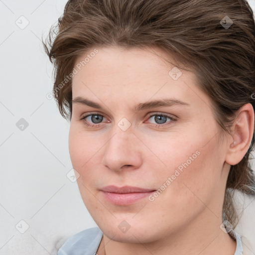 Joyful white young-adult female with medium  brown hair and blue eyes