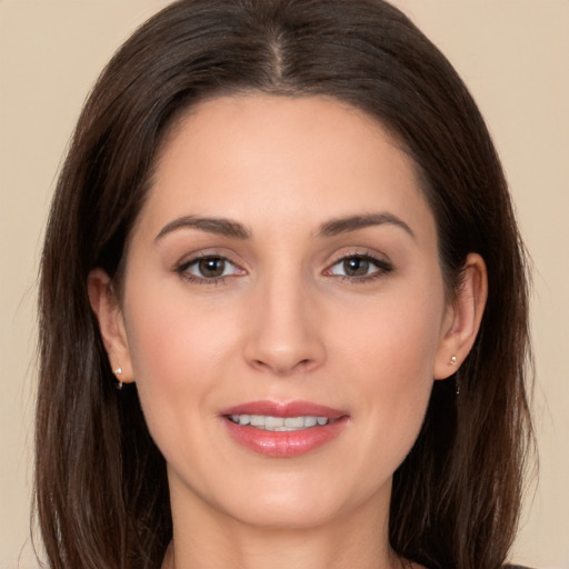 Joyful white young-adult female with long  brown hair and brown eyes