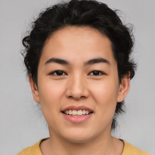 Joyful asian young-adult female with short  black hair and brown eyes