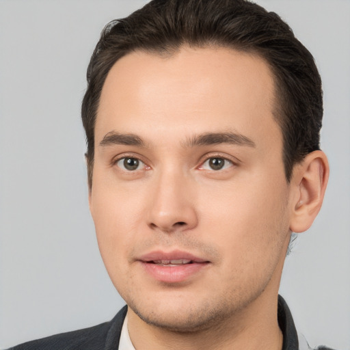 Joyful white young-adult male with short  brown hair and brown eyes