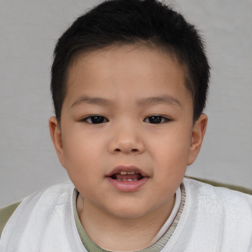 Joyful asian child male with short  brown hair and brown eyes
