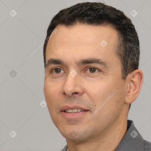 Joyful white adult male with short  black hair and brown eyes