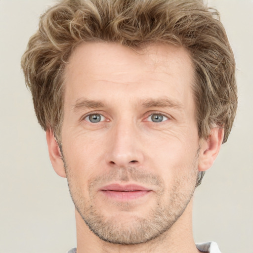 Joyful white adult male with short  brown hair and grey eyes