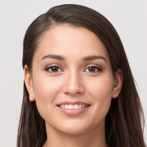 Joyful white young-adult female with long  brown hair and brown eyes