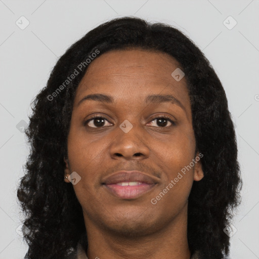 Joyful black young-adult female with long  brown hair and brown eyes