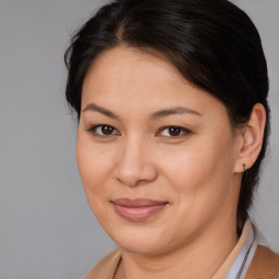 Joyful asian young-adult female with medium  brown hair and brown eyes