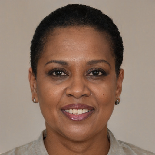 Joyful black adult female with short  brown hair and brown eyes