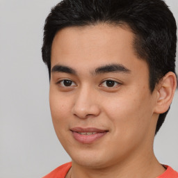 Joyful latino young-adult male with short  brown hair and brown eyes