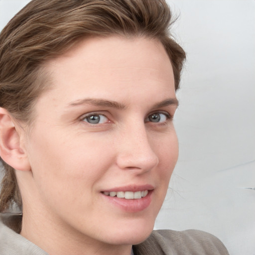 Joyful white young-adult female with medium  brown hair and blue eyes