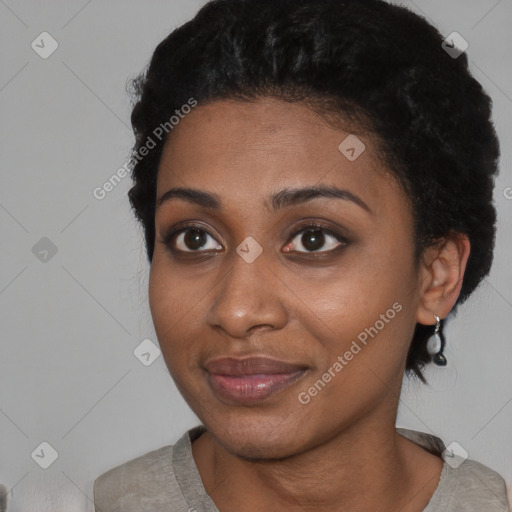 Joyful black young-adult female with short  black hair and brown eyes