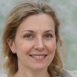 Joyful white adult female with medium  brown hair and grey eyes