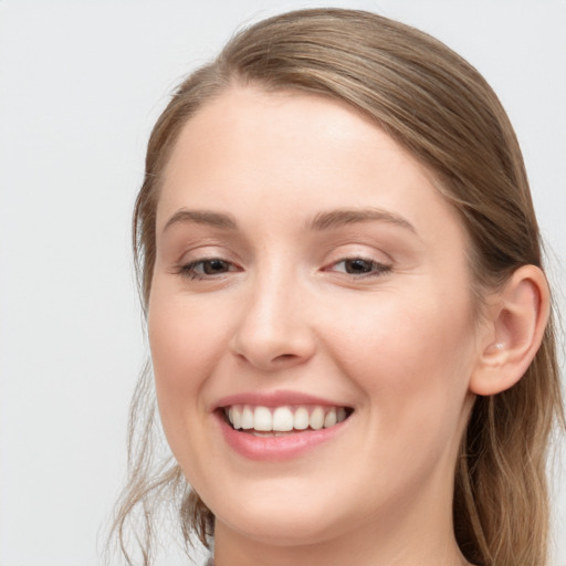 Joyful white young-adult female with long  brown hair and grey eyes