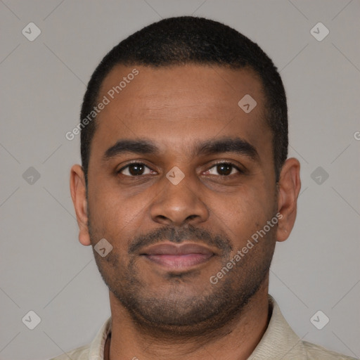 Joyful latino young-adult male with short  brown hair and brown eyes