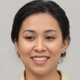 Joyful asian young-adult female with medium  brown hair and brown eyes