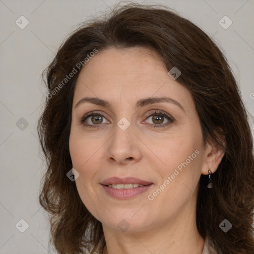 Joyful white adult female with medium  brown hair and green eyes