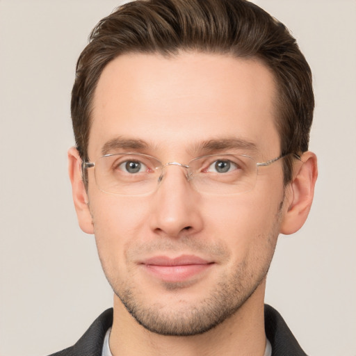 Joyful white young-adult male with short  brown hair and grey eyes