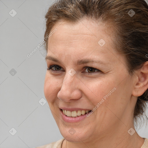 Joyful white adult female with medium  brown hair and brown eyes