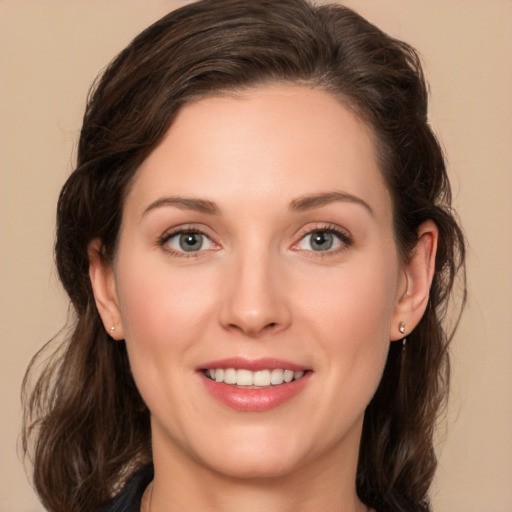 Joyful white young-adult female with long  brown hair and green eyes