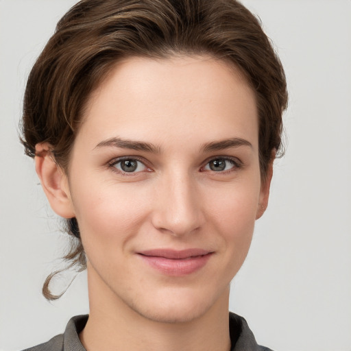 Joyful white young-adult female with short  brown hair and grey eyes