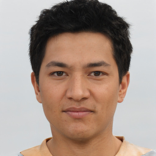 Joyful asian young-adult male with short  black hair and brown eyes