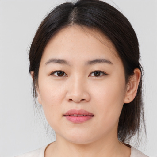 Joyful asian young-adult female with medium  brown hair and brown eyes