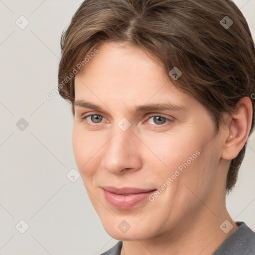 Joyful white young-adult female with short  brown hair and grey eyes