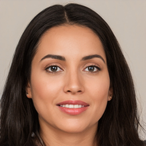 Joyful white young-adult female with long  brown hair and brown eyes