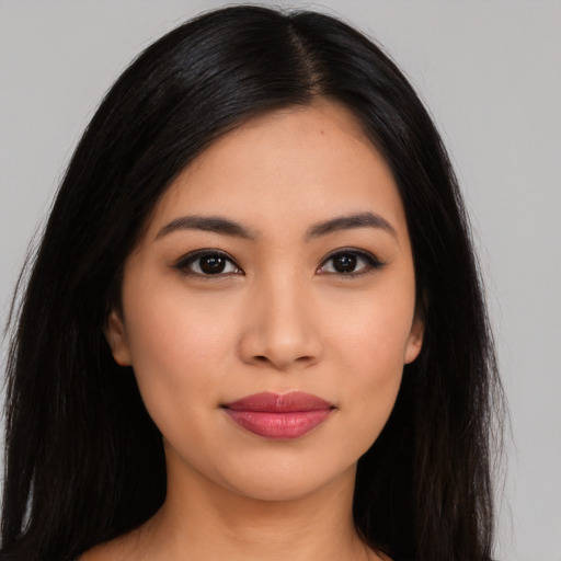 Joyful latino young-adult female with long  black hair and brown eyes