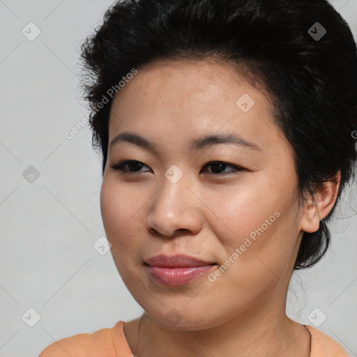 Joyful asian young-adult female with short  black hair and brown eyes