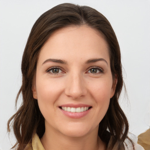 Joyful white young-adult female with long  brown hair and grey eyes