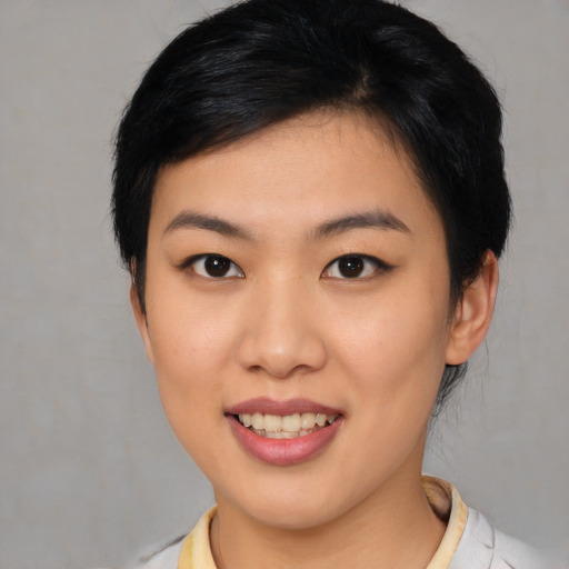 Joyful asian young-adult female with medium  black hair and brown eyes