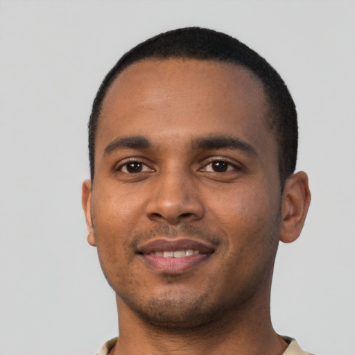 Joyful black young-adult male with short  black hair and brown eyes