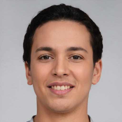 Joyful white young-adult male with short  black hair and brown eyes