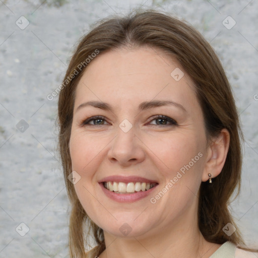 Joyful white adult female with medium  brown hair and brown eyes