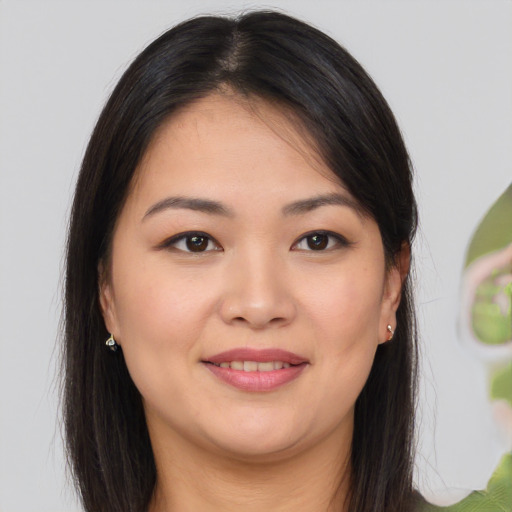 Joyful asian young-adult female with long  brown hair and brown eyes