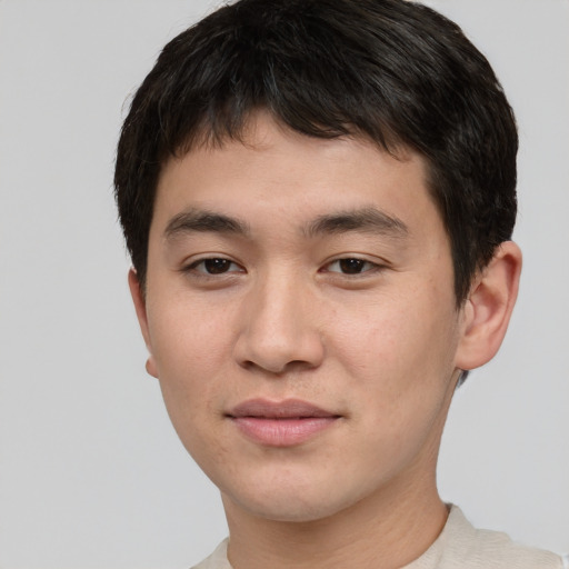 Joyful asian young-adult male with short  brown hair and brown eyes