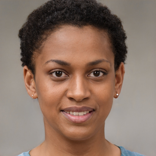 Joyful black young-adult female with short  brown hair and brown eyes