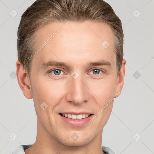 Joyful white young-adult male with short  brown hair and grey eyes